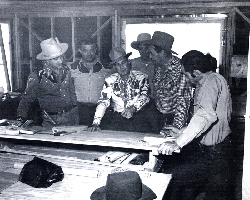 Lloyd Perryman, Bob Nolan, Bud Abbott, Tim Spencer and Dick Curtis reviewing plans